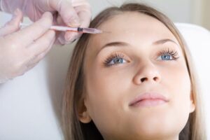 Closeup of a woman at a facial plastic surgeon's office getting a BOTOX brow lift.