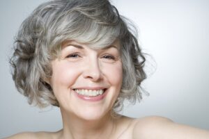Mature woman smiling, portrait, close-up